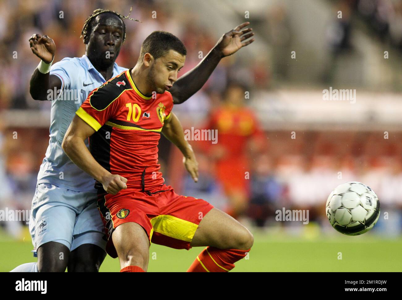 French Bacary Sagna and Belgium's Eden Hazard fight for the ball during a friendly game of the Belgian national soccer team Red Devils against France's national soccer team, Wednesday 14 August 2013, in the King Baudouin Stadium (Stade Roi Baudouin/Koning Boudewijnstadion), in Brussels.  Stock Photo
