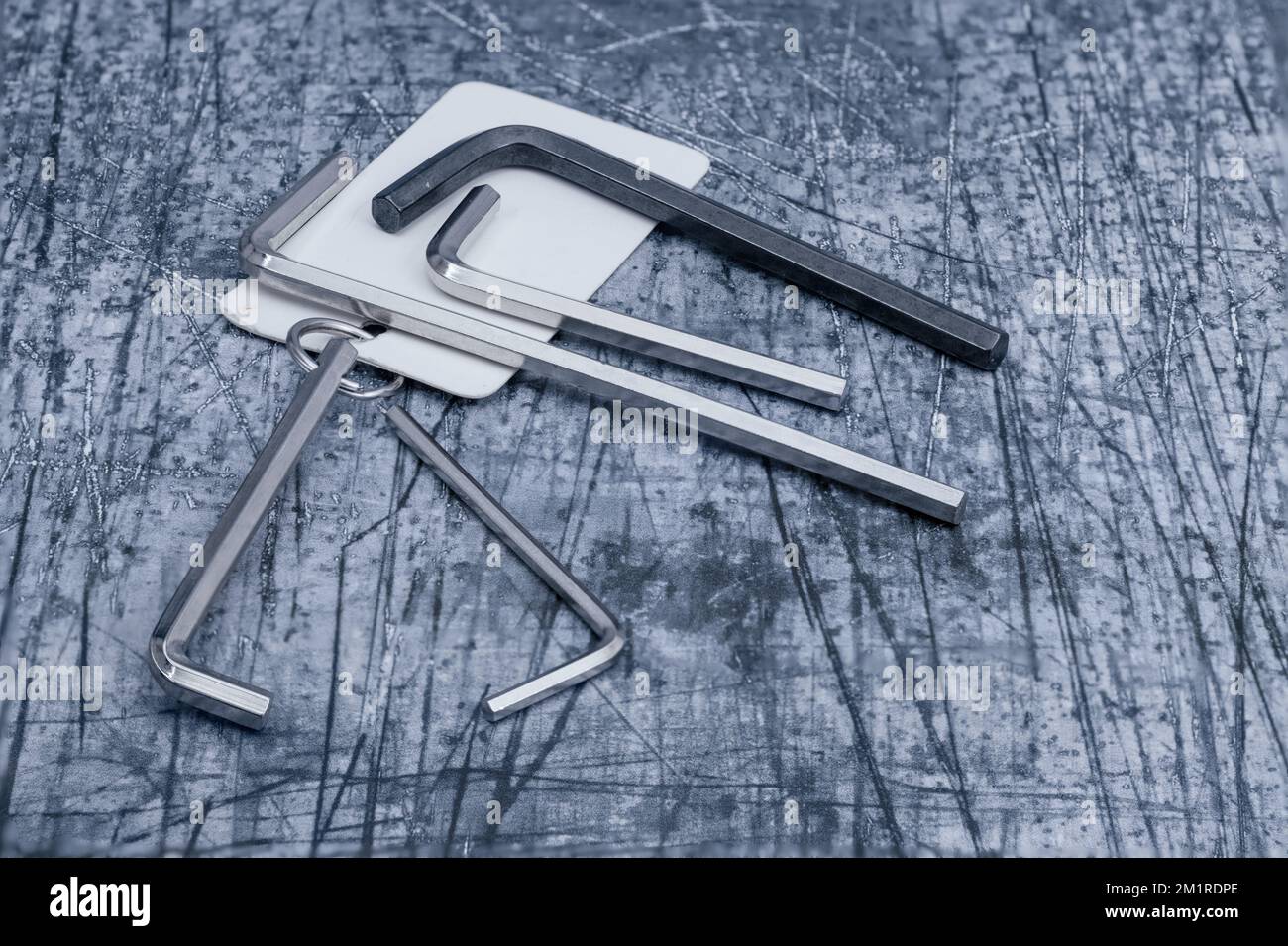 bunch of standard imperial and metric allen keys isolated on a concrete