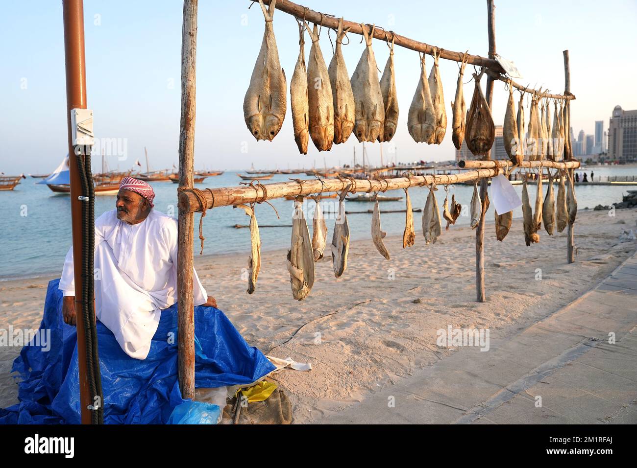 A worker selling fish at the Katara Cultural Village in Doha, Qatar