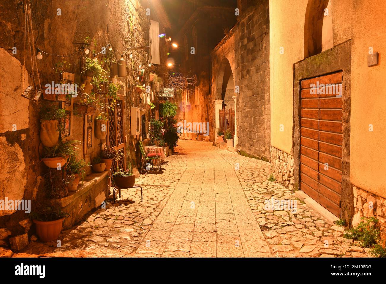 A narrow street among the old stone houses of a medieval quarter of the