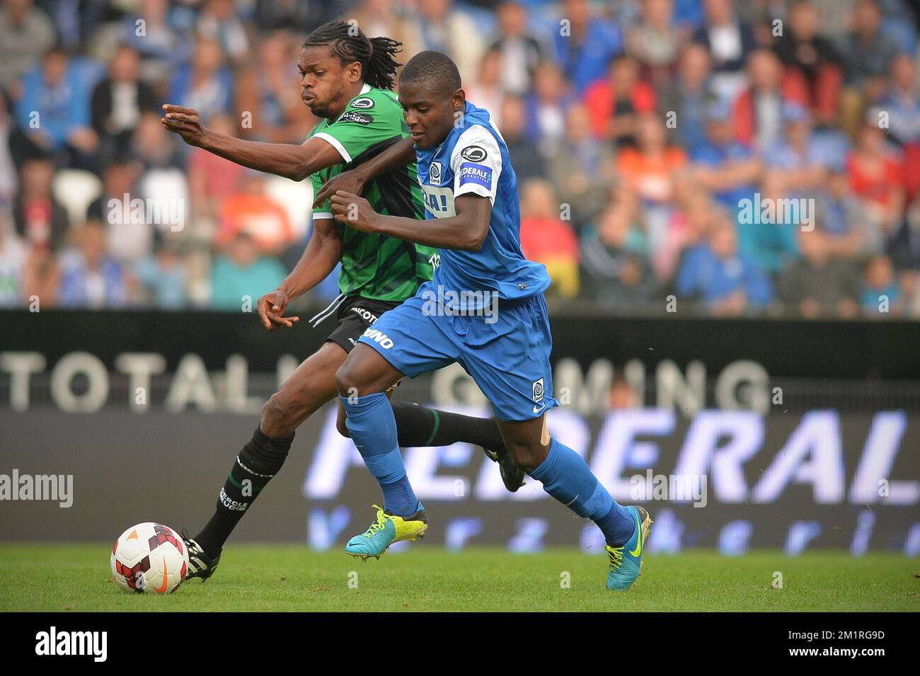 Cercle's Michael Uchebo and Genk's Derrick Tshimanga in action during the Jupiler Pro League match between KRC Genk and Cercle Brugge KSV, in Genk, Sunday 25 August 2013, on day 5 of the Belgian soccer championship.  Stock Photo