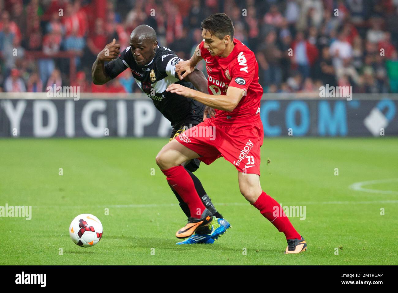 Mechelen's Benjamin Mokulu and Kortrijk's Zarko Tomasevic fight for the ball during the Jupiler Pro League match between KV Kortrijk and KV Mechelen, in Kortrijk, Saturday 24 August 2013, on day 5 of the Belgian soccer championship.  Stock Photo