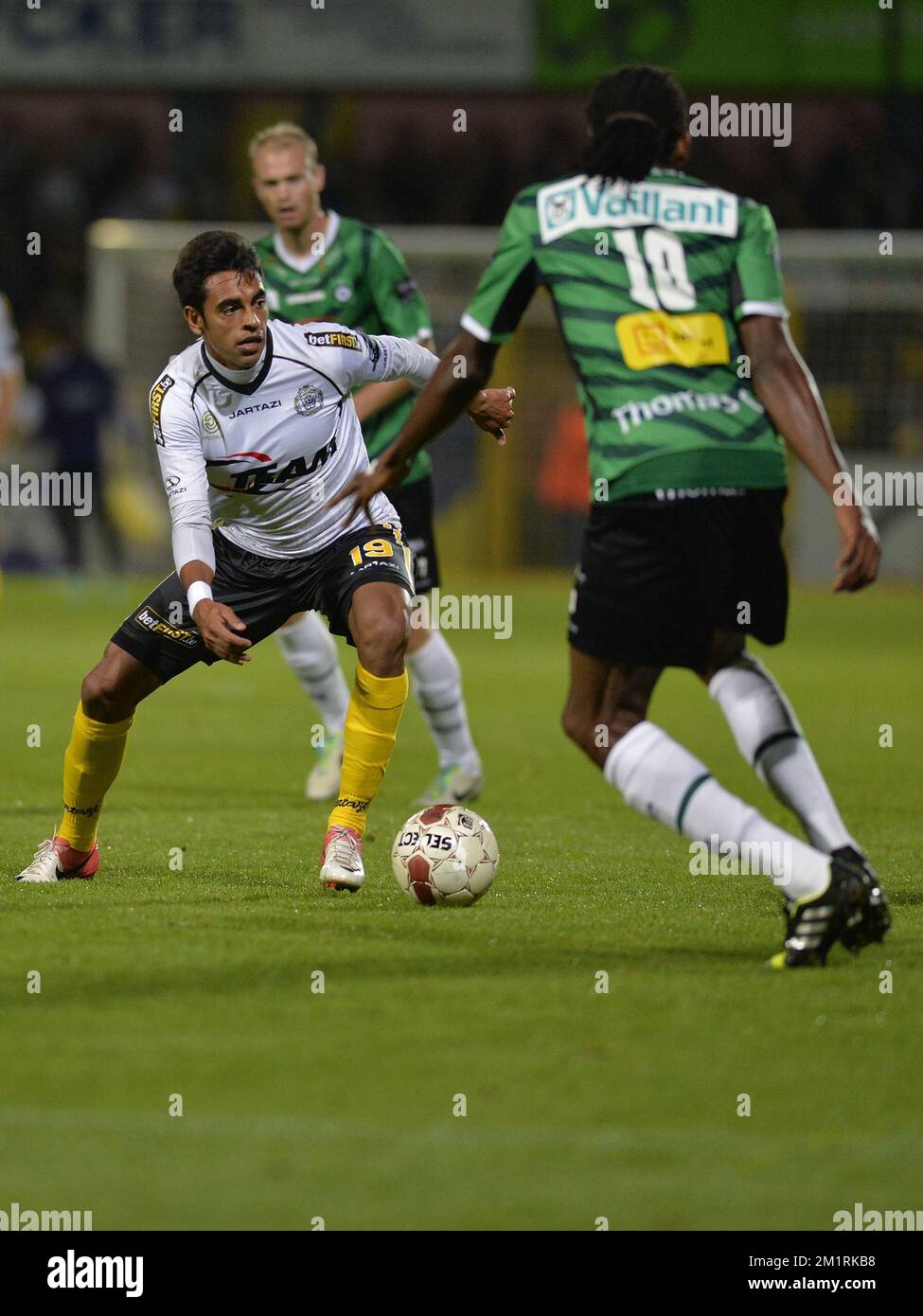Lokeren's Sergio Junior Dutra and Cercle's Michael Uchebo fight for the ball at the Jupiler Pro League match between Lokeren and Cercle Brugge, in Lokeren, Saturday 14 September 2013, on the seventh day of the Belgian soccer championship.  Stock Photo