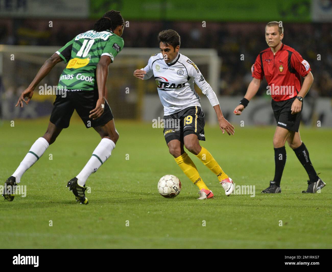Cercle's Michael Uchebo and Lokeren's Sergio Junior Dutra fight for the ball at the Jupiler Pro League match between Lokeren and Cercle Brugge, in Lokeren, Saturday 14 September 2013, on the seventh day of the Belgian soccer championship.  Stock Photo