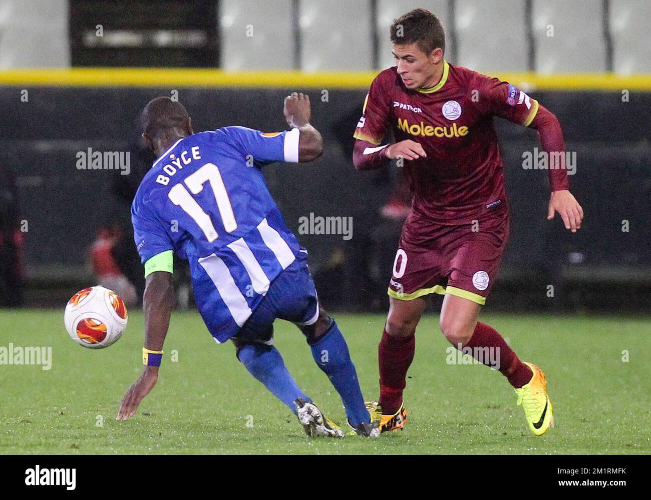 Wigan's Emmerson Boyce and Essevee's Thorgan Hazard fight for the ball during a match of Belgian first division soccer team Zulte Waregem and English club Wigan Athletic F.C., in group D, on the first day of the group stage of the Europa League tournament in Brugge stadium, Thursday 19 September 2013. BELGA PHOTO VIRGINIE LEFOUR Stock Photo