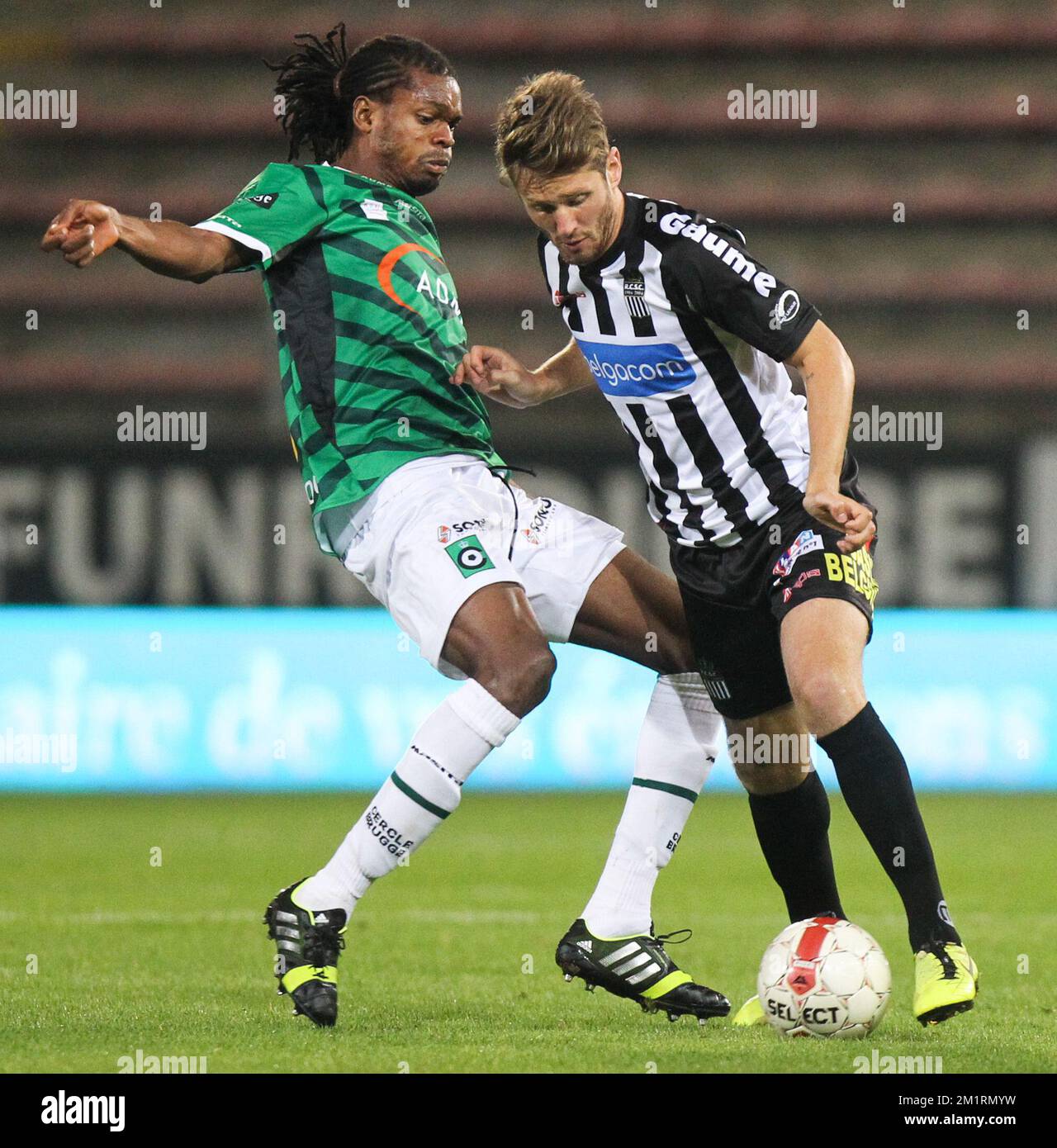 Cercle's Michael Uchebo and Charleroi's Damien Marcq fight for the ball during the Jupiler Pro League match between Sporting Charleroi and Cercle Brugge KSV, in Charleroi, Saturday 21 September 2013, on day 8 of the Belgian soccer championship. BELGA PHOTO VIRGINIE LEFOUR Stock Photo