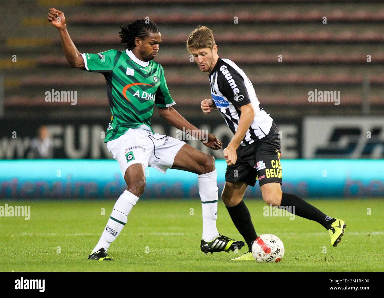 Cercle's Michael Uchebo and Charleroi's Damien Marcq fight for the ball during the Jupiler Pro League match between Sporting Charleroi and Cercle Brugge KSV, in Charleroi, Saturday 21 September 2013, on day 8 of the Belgian soccer championship. BELGA PHOTO VIRGINIE LEFOUR Stock Photo
