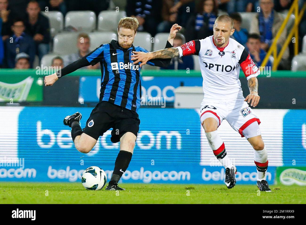 Club's Tom Hogli and OHL's Muhamed Subasic fight for the ball during the Jupiler Pro League match between Club Brugge and Oud-Heverlee Leuven, in Brugge, Saturday 05 October 2013, on day 10 of the Belgian soccer championship.  Stock Photo