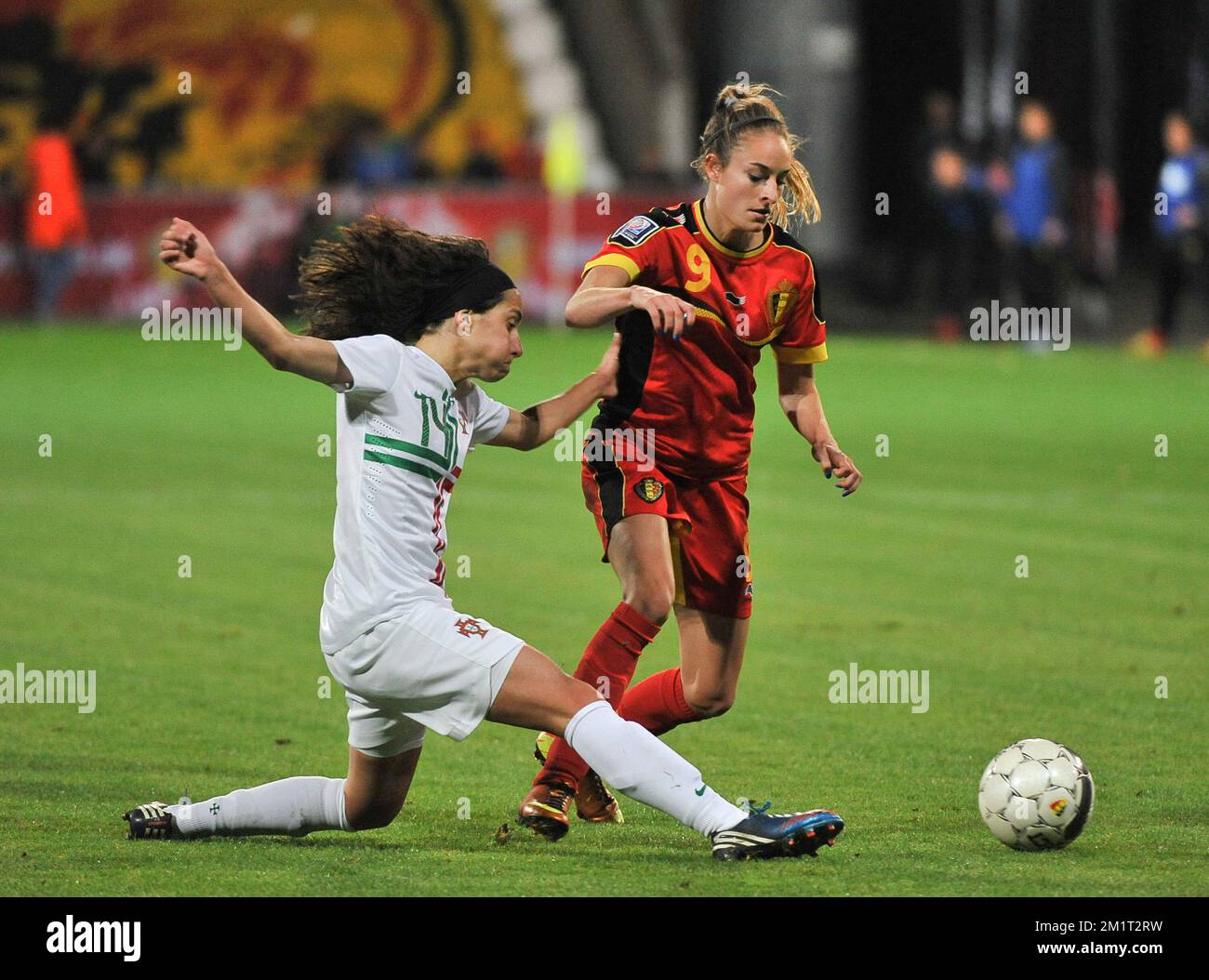 20131031 - ANTWERPEN , BELGIUM : Belgian Tessa Wullaert (right) pictured avoiding the tackle from Portugese Dolores Silva (14) during the female soccer match between Belgium and Portugal , on the fourth matchday in group 5 of the UEFA qualifying round to the FIFA Women World Cup in Canada 2015 at Het Kiel stadium , Antwerp . Thursday 31st October 2013. PHOTO DAVID CATRY Stock Photo