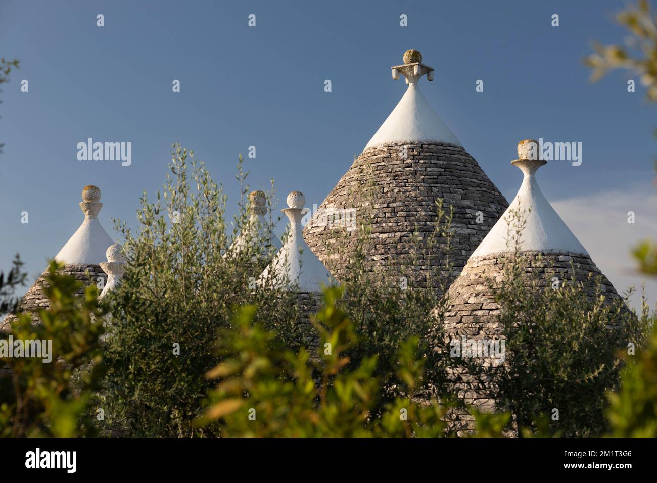 Conical roofs of trulli buildings with decorative pinnacles in the