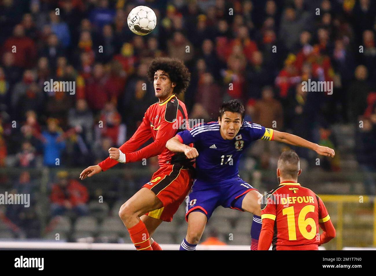 Belgium's Marouane Fellaini and Japan's Makoto Hasebe fight for the ball during the friendly match between Belgian national soccer team Red Devils and Japan, on Tuesday 19 November 2013, in Brussels. BELGA PHOTO BRUNO FAHY Stock Photo