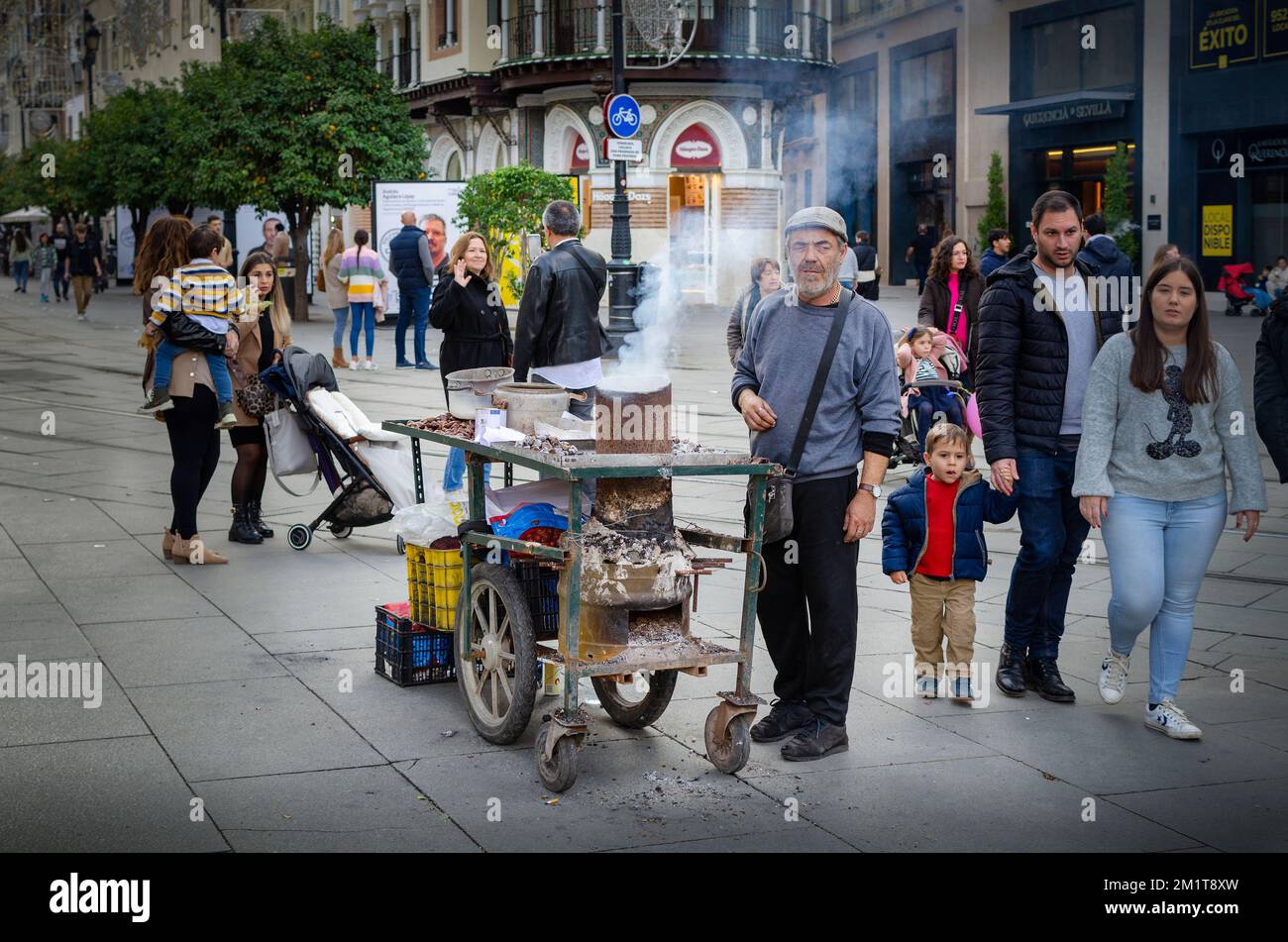 Seville, Spain; December 6, 2022: . Chestnut seller in a street of Seville Stock Photo