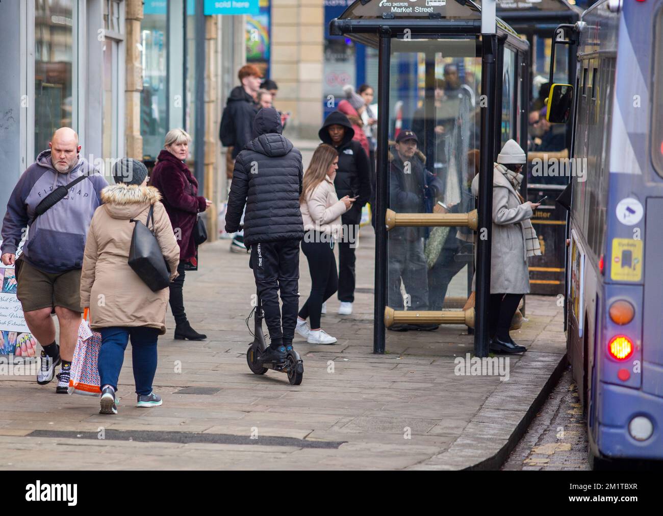 A young person on a electric scooter (e scooter ) rides on the pavement