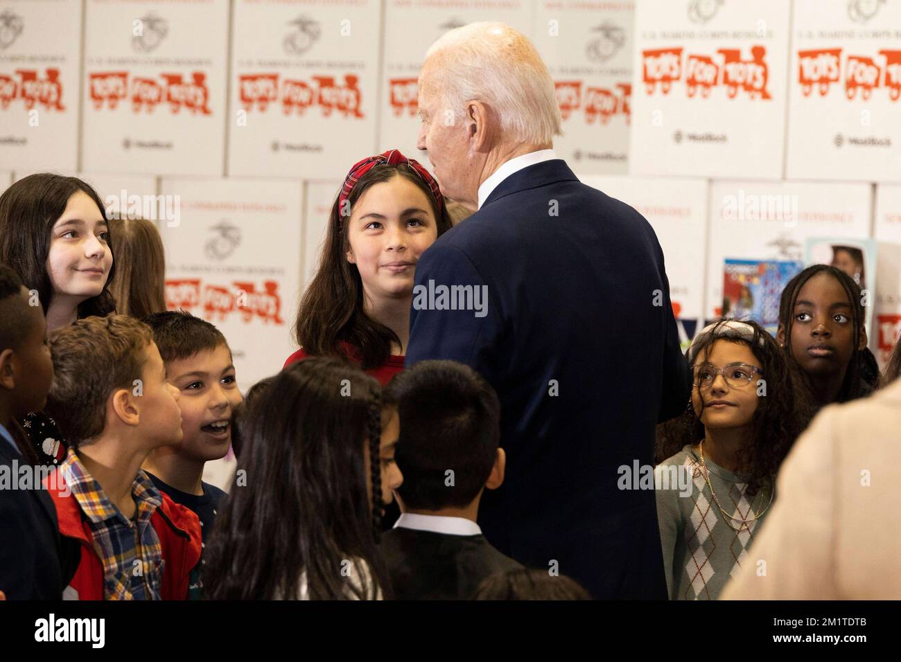 Arlington, United States. 12th Dec, 2022. U.S. President Joe Biden talks with children of military families during a Marine Corps Reserve sorting event for Toys for Tots at Joint Base Myer-Henderson Hall, December 12, 2022 in Arlington, Virginia. Credit: Adam Schultz/White House Photo/Alamy Live News Stock Photo