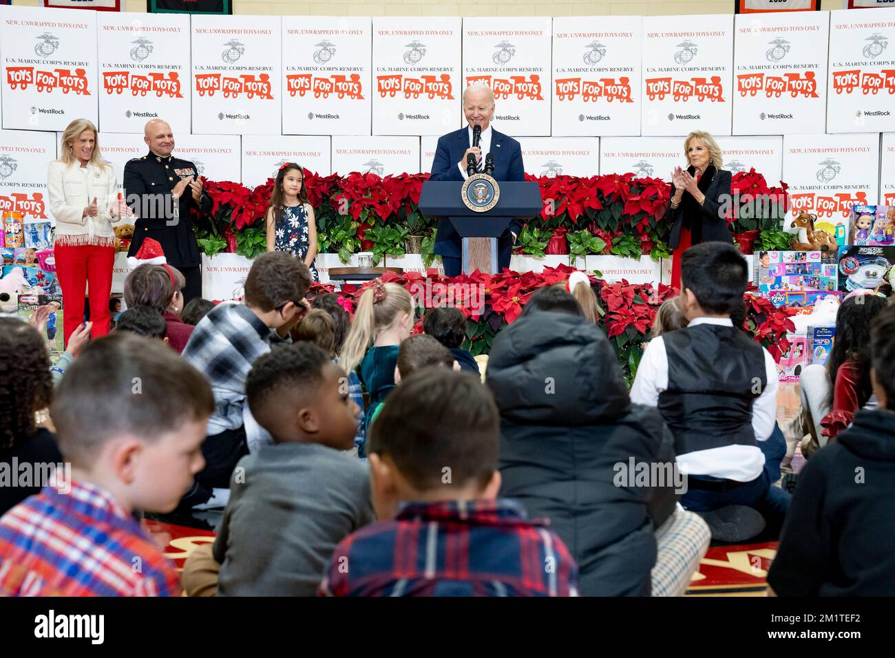 Arlington, United States. 12th Dec, 2022. U.S. President Joe Biden delivers remarks to military families during a Marine Corps Reserve sorting event for Toys for Tots with First Lady Jill Biden, right, at Joint Base Myer-Henderson Hall, December 12, 2022 in Arlington, Virginia. Credit: Adam Schultz/White House Photo/Alamy Live News Stock Photo