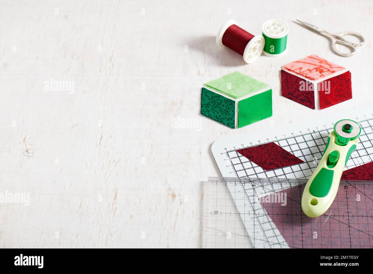 Small quilt, cutting mat and sewing and quilting accessories Stock Photo -  Alamy
