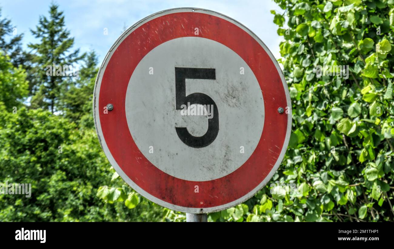 A speed limit 5 kilometer per hour warning sign at the street Stock Photo