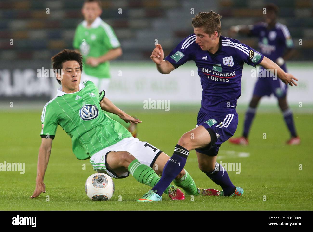20140110 - ABU DHABI, UNITED ARAB EMIRATES: Wolfsburg's  Koo Ja-Cheol and Anderlecht's Dennis Praet fight for the ball during a friendly soccer game between Anderlecht and German VfL Wolfsburg on day five of the winter camp of Belgian first division soccer team RSCA Anderlecht in Abu Dhabi, United Arab Emirates (UAE), Friday 10 January 2014. BELGA PHOTO VIRGINIE LEFOUR Stock Photo