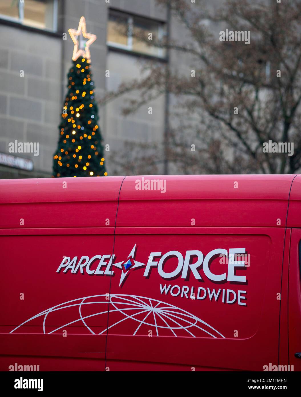 A ParcelForce van with a Christmas tree and Christmas star and lights