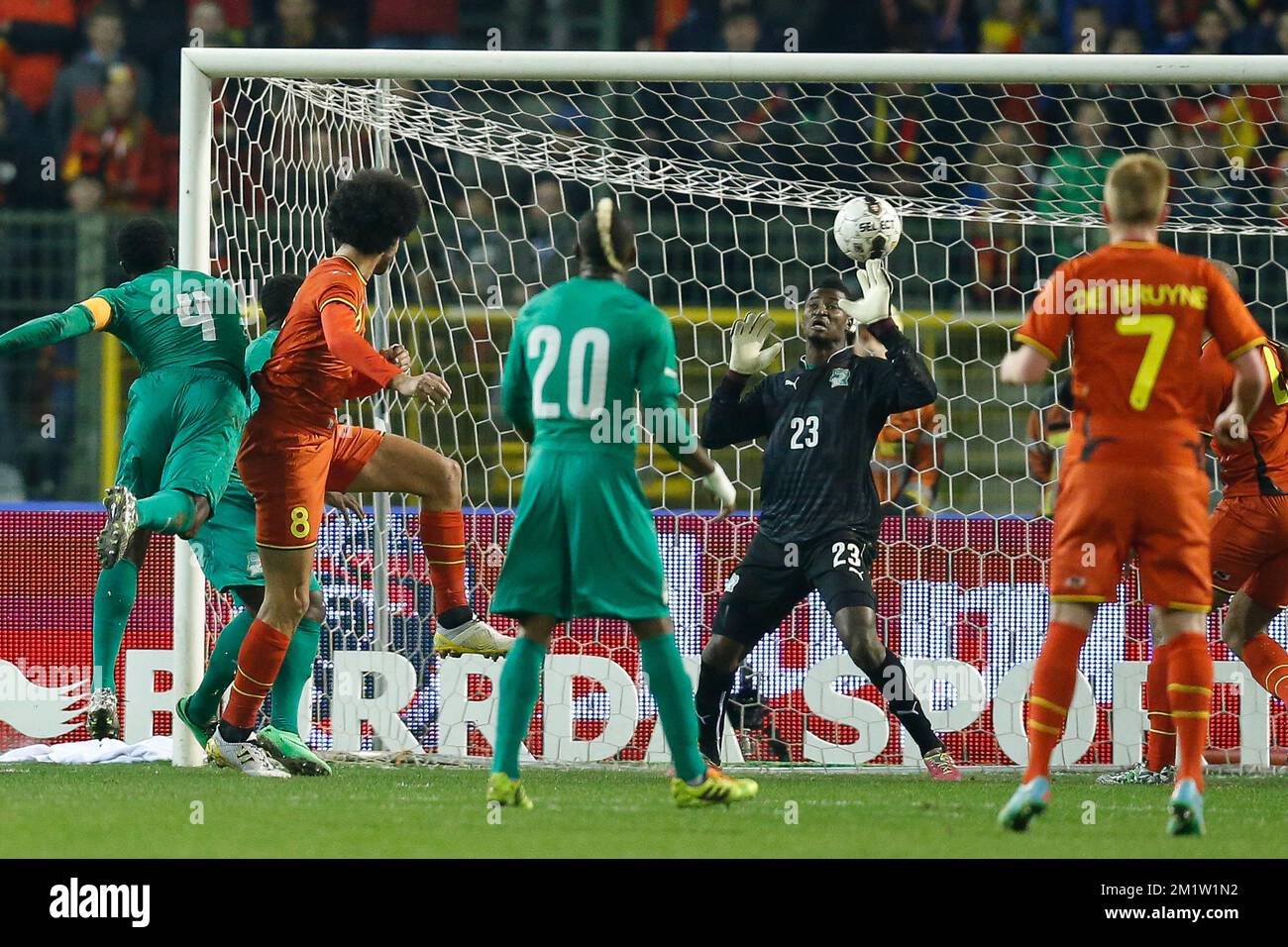 Belgium's Marouane Fellaini (2nd L) scores the 1-0 goal and Ivory Coast's goalkeeper Sayouba Mande can not stop it at a friendly soccer game between the Belgian national team the Red Devils and Ivory Coast, Wednesday 05 March 2014 in Brussels.  Stock Photo
