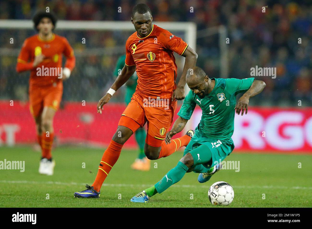 Belgium's Christian Benteke and Ivory Coast's Didier Zokora fight for the ball during a friendly soccer game between the Belgian national team the Red Devils and Ivory Coast, Wednesday 05 March 2014 in Brussels. Stock Photo