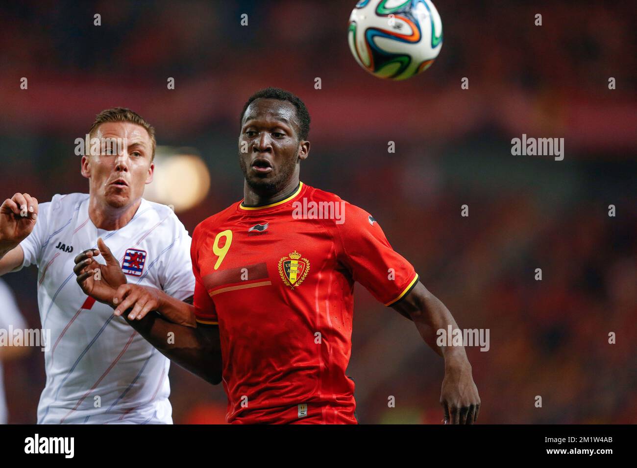 Luxembourg's Tom Schnell and Belgium's Romelu Lukaku fight for the ball  Stock Photo