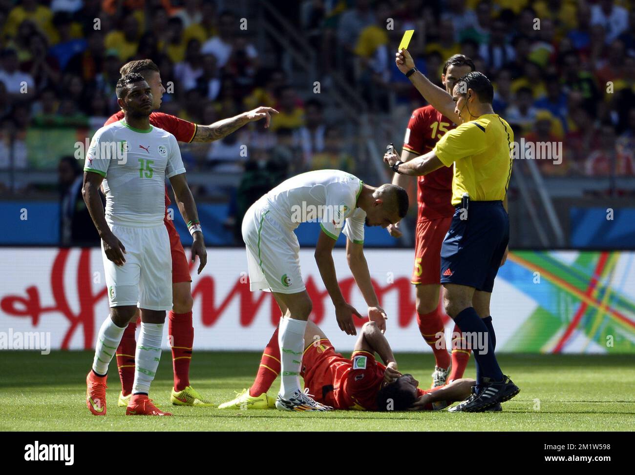 Belgium's Moussa Dembele lay down next to, referee Marco Rodriguez, Belgium's Daniel Van Buyten (R) and Algeria's El Arbi Hillel Soudani (L) at a soccer game between Belgian national team The Red Devils and Algeria in Belo Horizonte, Brazil, the first game in Group H of the first round of the 2014 FIFA World Cup, Tuesday 17 June 2014.  Stock Photo