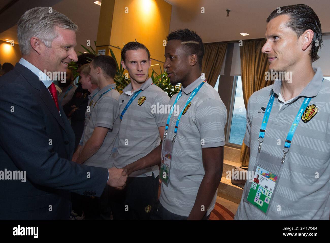 King Philippe - Filip of Belgium shakes hands with and Belgium's Divock Origi next to Belgium's Daniel Van Buyten as Royal couple meet Belgian team Red Devils won their second game over Russia to qualify for 1/8 finals, in Rio de Janeiro, Brazil, at the 2014 FIFA World Cup, Sunday 22 June 2014. Stock Photo