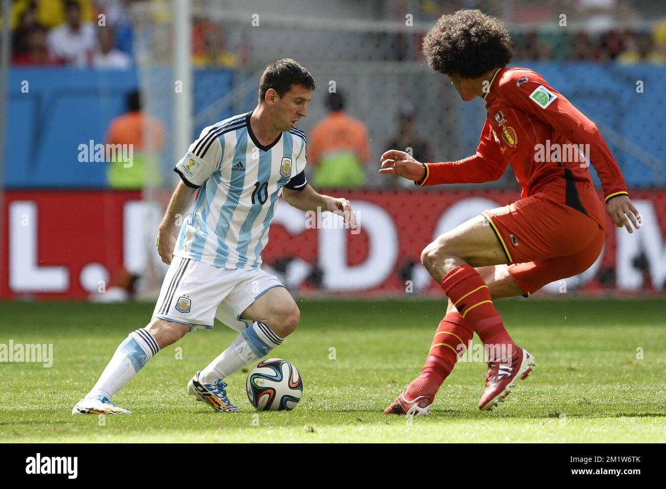 Argentina's Lionel Messi and Belgium's Marouane Fellaini fight for the ball during the quarter final match between Belgian national soccer team Red Devils and Argentina, in Estadio Nacional Mane Garrincha, in Brasilia, Brazil, during the 2014 FIFA World Cup, Saturday 05 July 2014.  BELGA PHOTO DIRK WAEM Stock Photo