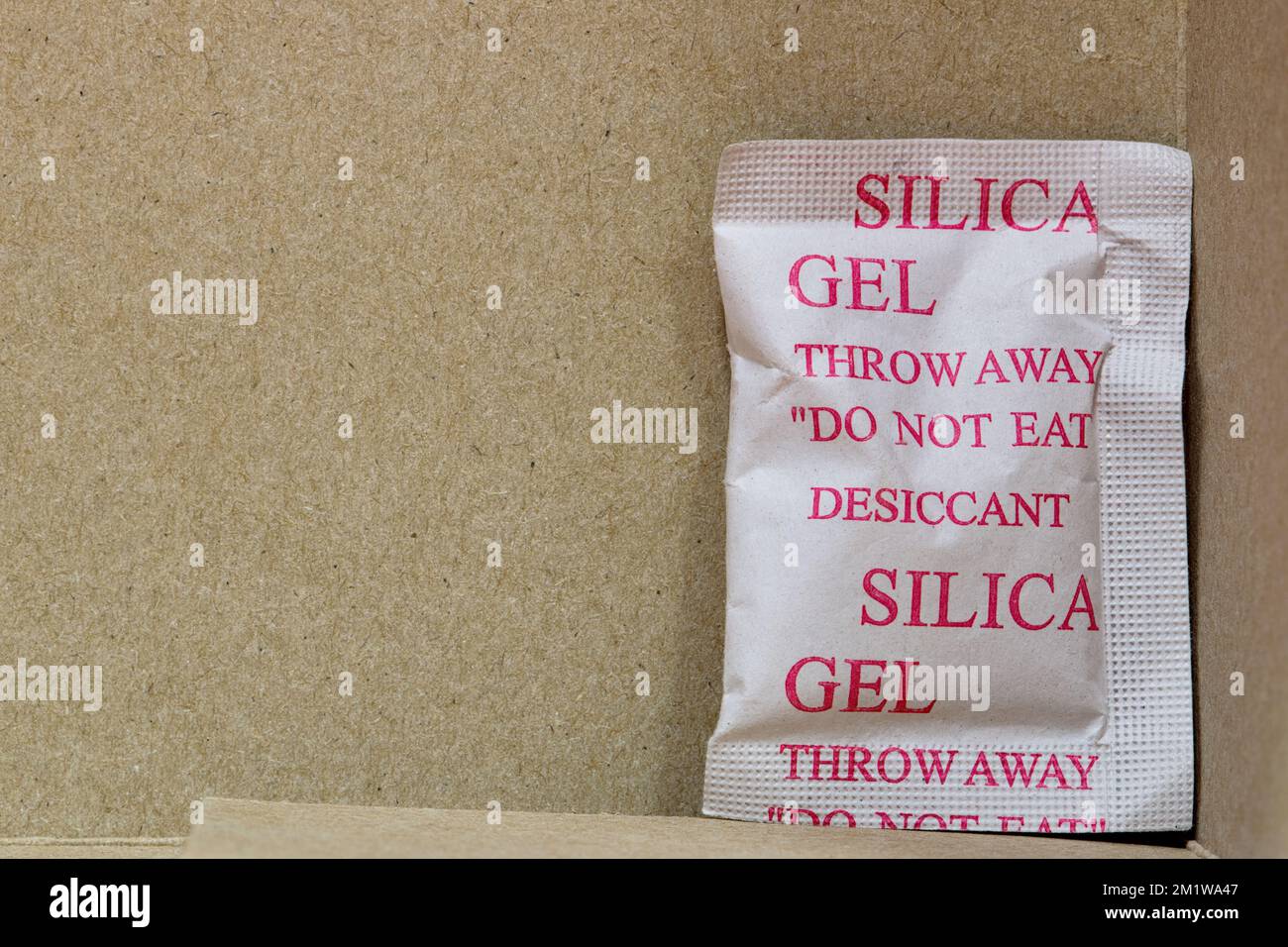 Single Silica gel packet in the bottom corner of a cardboard box