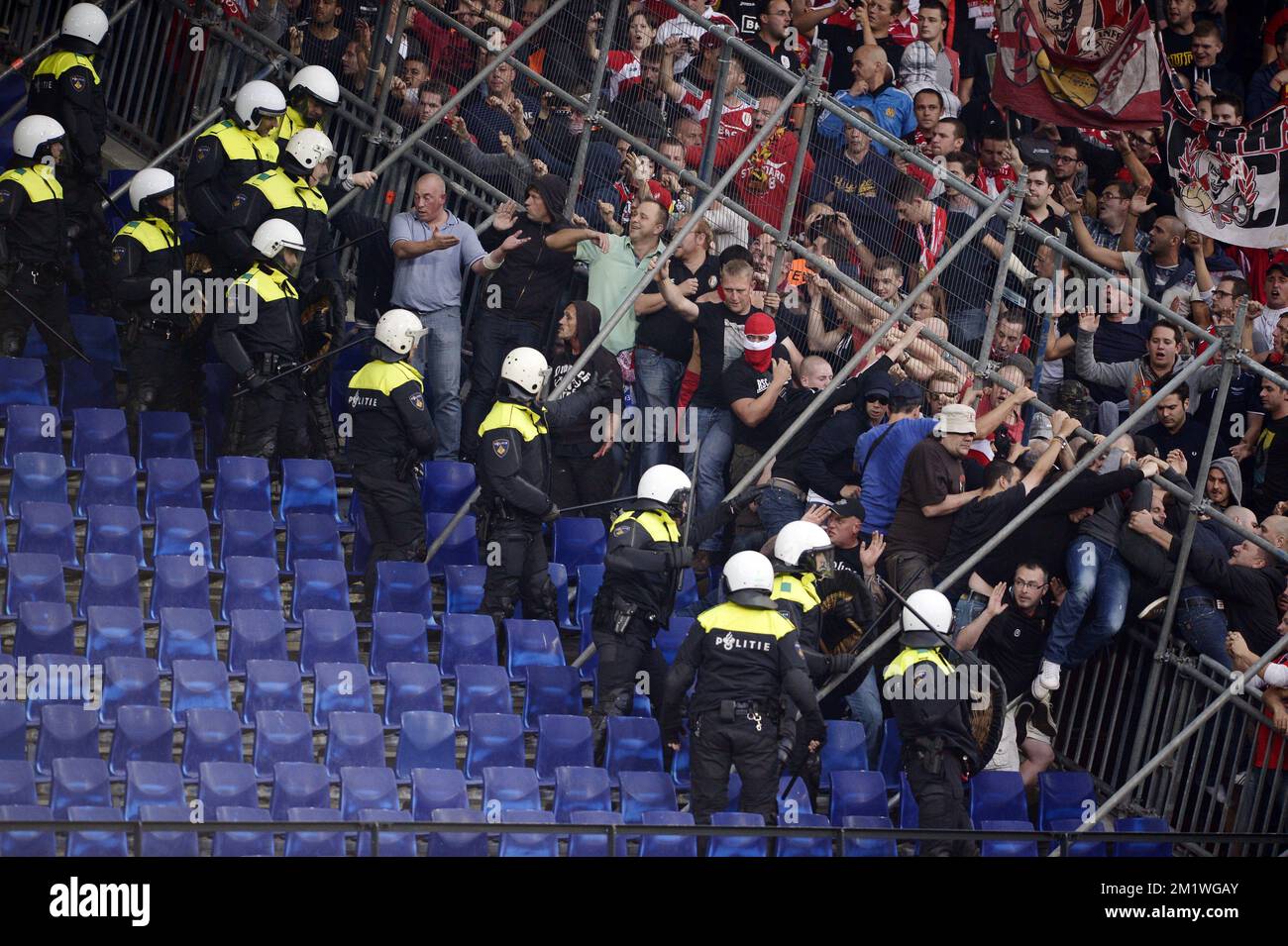 Standard's supporters fight before a soccer game between Dutch club Feyenoord Rotterdam and Belgian first division team Standard de Liege, in the 'De Kuip' stadium in Rotterdam, Netherlands, Thursday 02 October 2014, the second game in the group stage of the UEFA Europa League, in group G. Stock Photo
