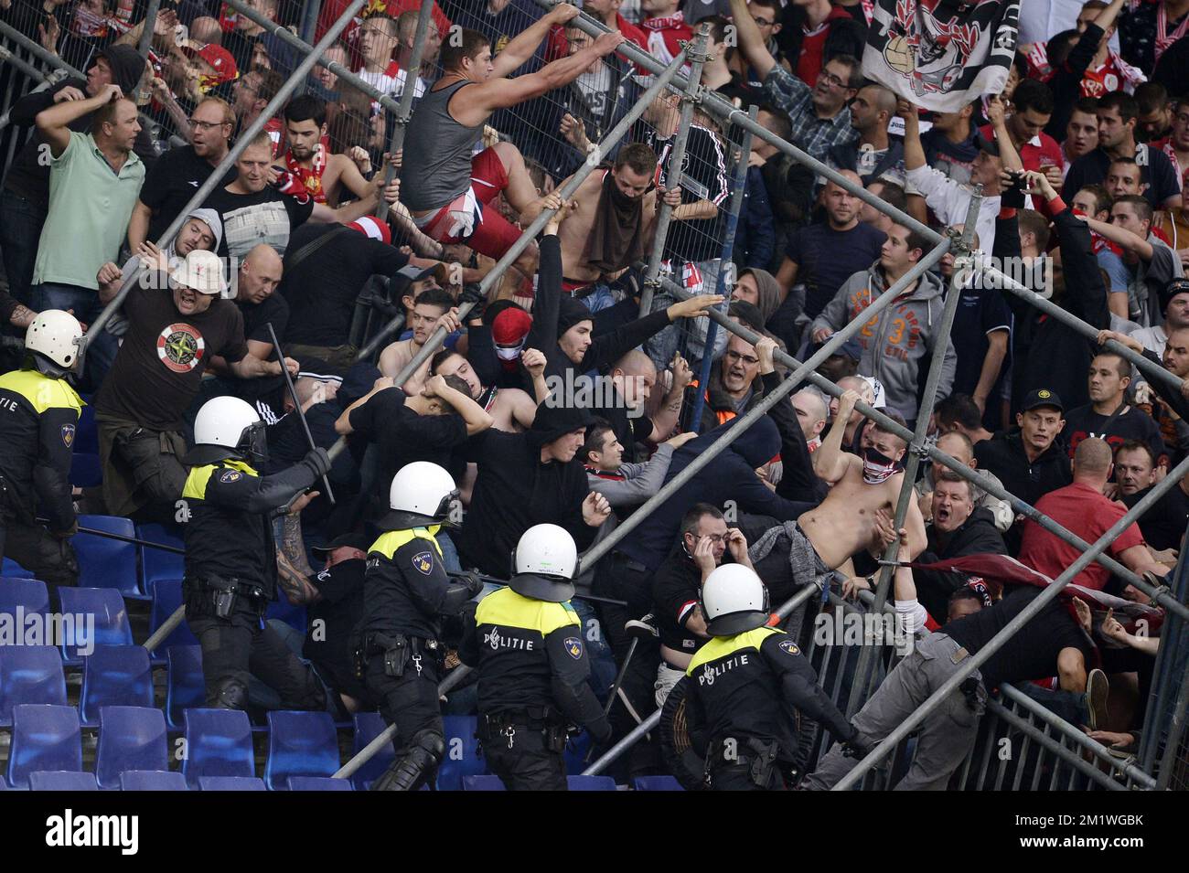 Standard's supporters fight before a soccer game between Dutch club Feyenoord Rotterdam and Belgian first division team Standard de Liege, in the 'De Kuip' stadium in Rotterdam, Netherlands, Thursday 02 October 2014, the second game in the group stage of the UEFA Europa League, in group G. Stock Photo