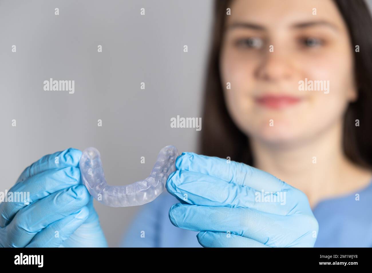 Doctor holding dental mouthguard, splint for the treatment of dysfunction of the temporomandibular joints, bruxism, malocclusion, to relax the muscles Stock Photo