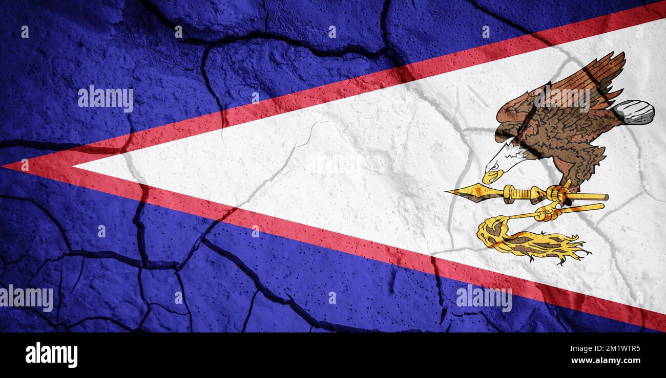 Flag of American Samoa. American Samoa symbol. Flag on the background of dry cracked earth. Samoa flag with drought concept Stock Photo