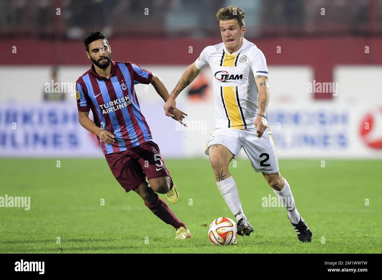 20141023 - TRABZON, TURKEY: Trabzonspor's Mehmet Ekici and Lokeren's Alexander Scholz fight for the ball during a game between Turkish club Trabzonspor AS and Belgian soccer team KSC Lokeren OVL in the Huseyin Avni Aker Stadium in Trabzon, Thursday 23 October 2014. It is the third day of the group stage of the UEFA Europa League competition, in group L. BELGA PHOTO YORICK JANSENS Stock Photo