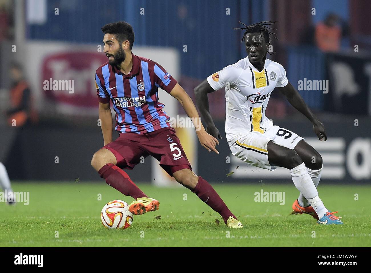 20141023 - TRABZON, TURKEY: Trabzonspor's Mehmet Ekici and Lokeren's Mbaye Leye fight for the ball during a game between Turkish club Trabzonspor AS and Belgian soccer team KSC Lokeren OVL in the Huseyin Avni Aker Stadium in Trabzon, Thursday 23 October 2014. It is the third day of the group stage of the UEFA Europa League competition, in group L. BELGA PHOTO YORICK JANSENS Stock Photo