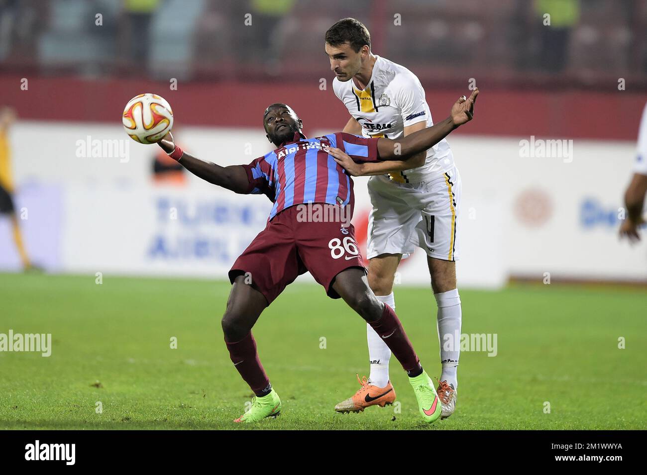 20141023 - TRABZON, TURKEY: Trabzonspor's Mustapha Yatabare and Lokeren's Gregory Mertens fight for the ball during a game between Turkish club Trabzonspor AS and Belgian soccer team KSC Lokeren OVL in the Huseyin Avni Aker Stadium in Trabzon, Thursday 23 October 2014. It is the third day of the group stage of the UEFA Europa League competition, in group L. BELGA PHOTO YORICK JANSENS Stock Photo