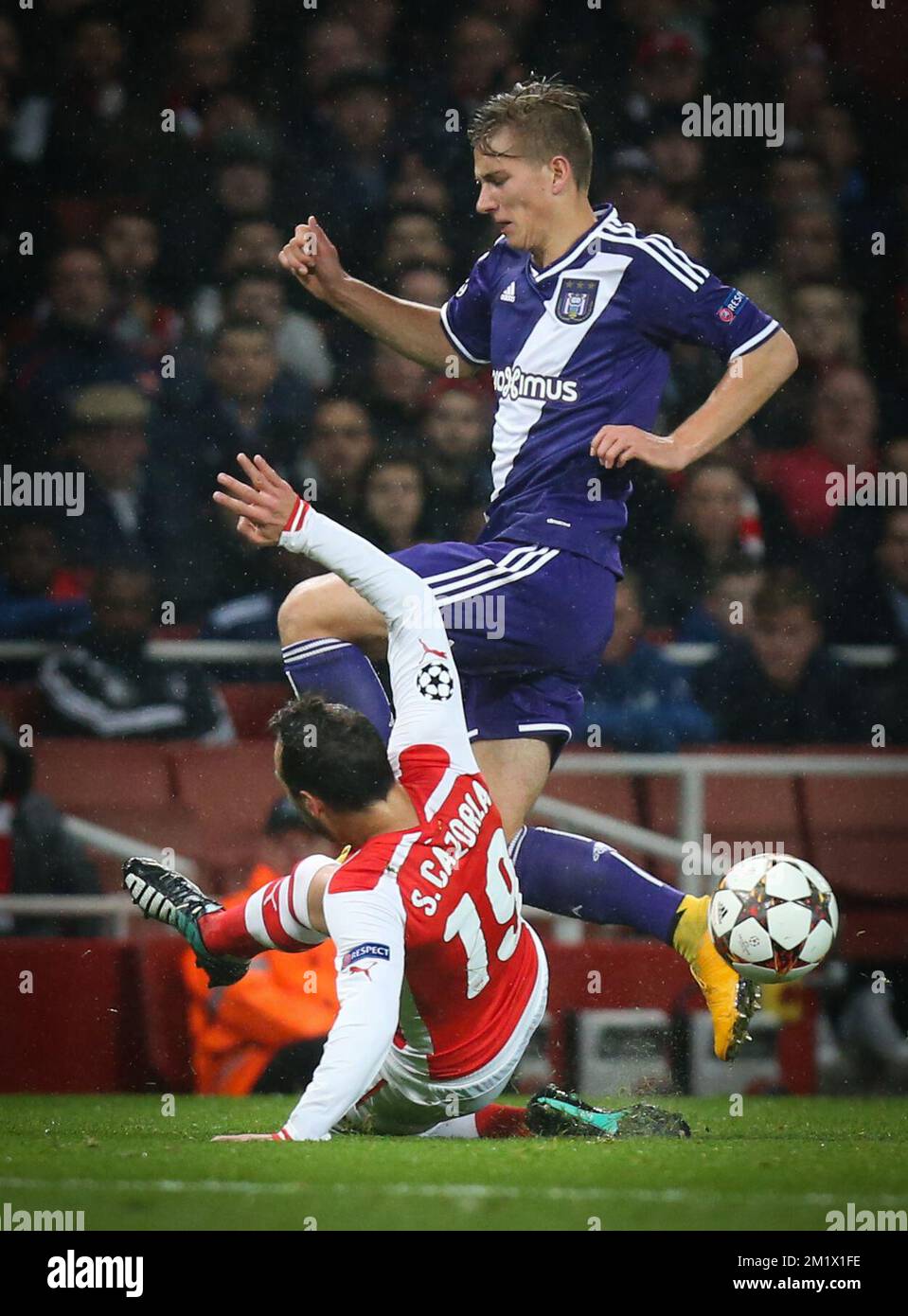 Arsenal's Santi Cazorla and Anderlecht's Dennis Praet fight for the ball during the match between English team Arsenal and Belgian RSCA Anderlecht in the Emirates stadium in London, England, Tuesday 04 November 2014, on the fourth day of the group stage of the UEFA Champions League competition, in the group D.  Stock Photo