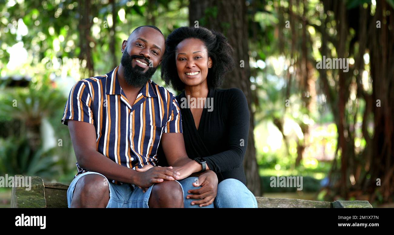 African couple posing for camera outside at park Stock Photo - Alamy