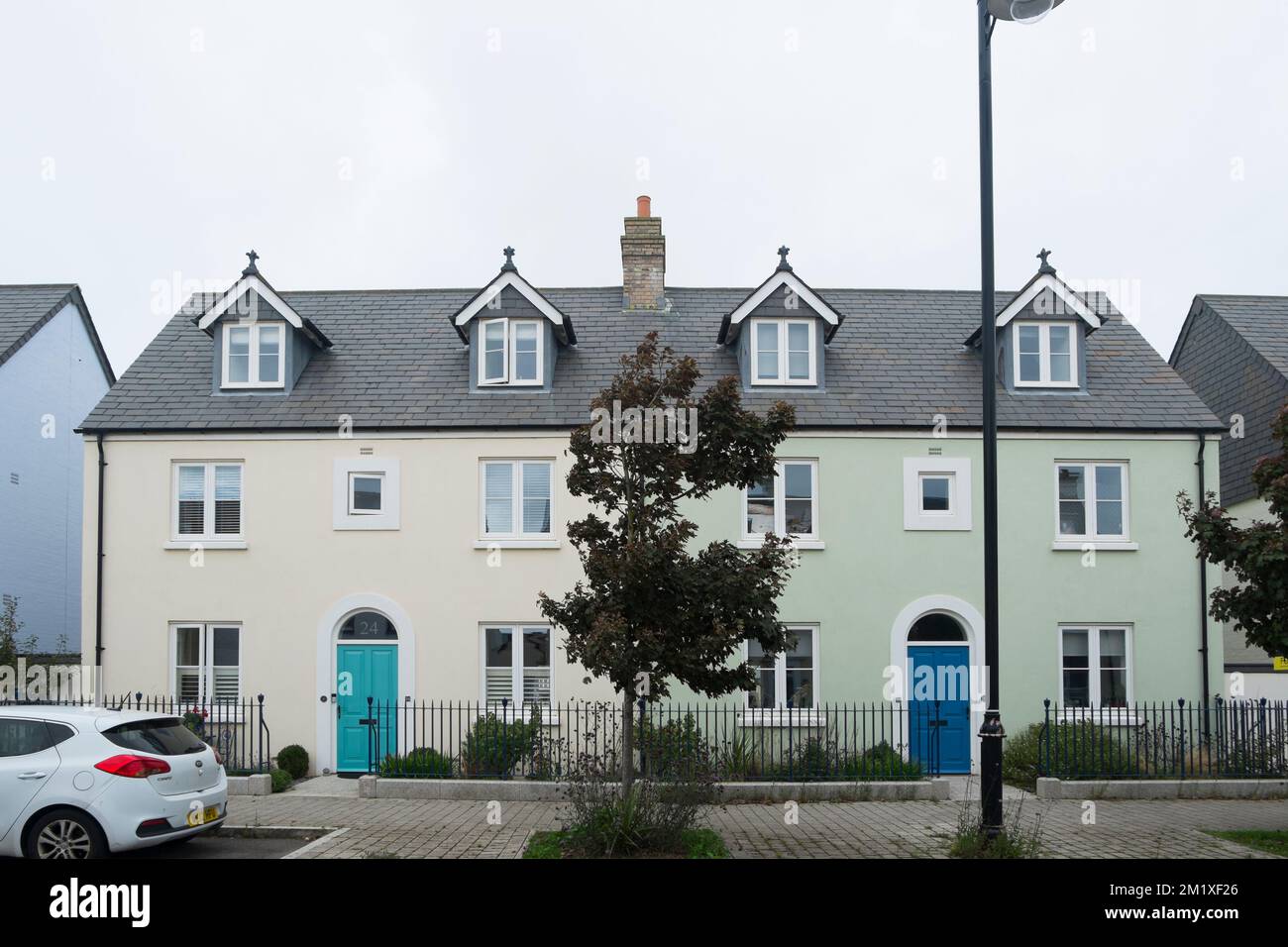 Two semi-detached, three storey houses on Stret Euther Penndragon,Nansledan, a development by the Duchy of Cornwall in Newquay, South West England, UK Stock Photo