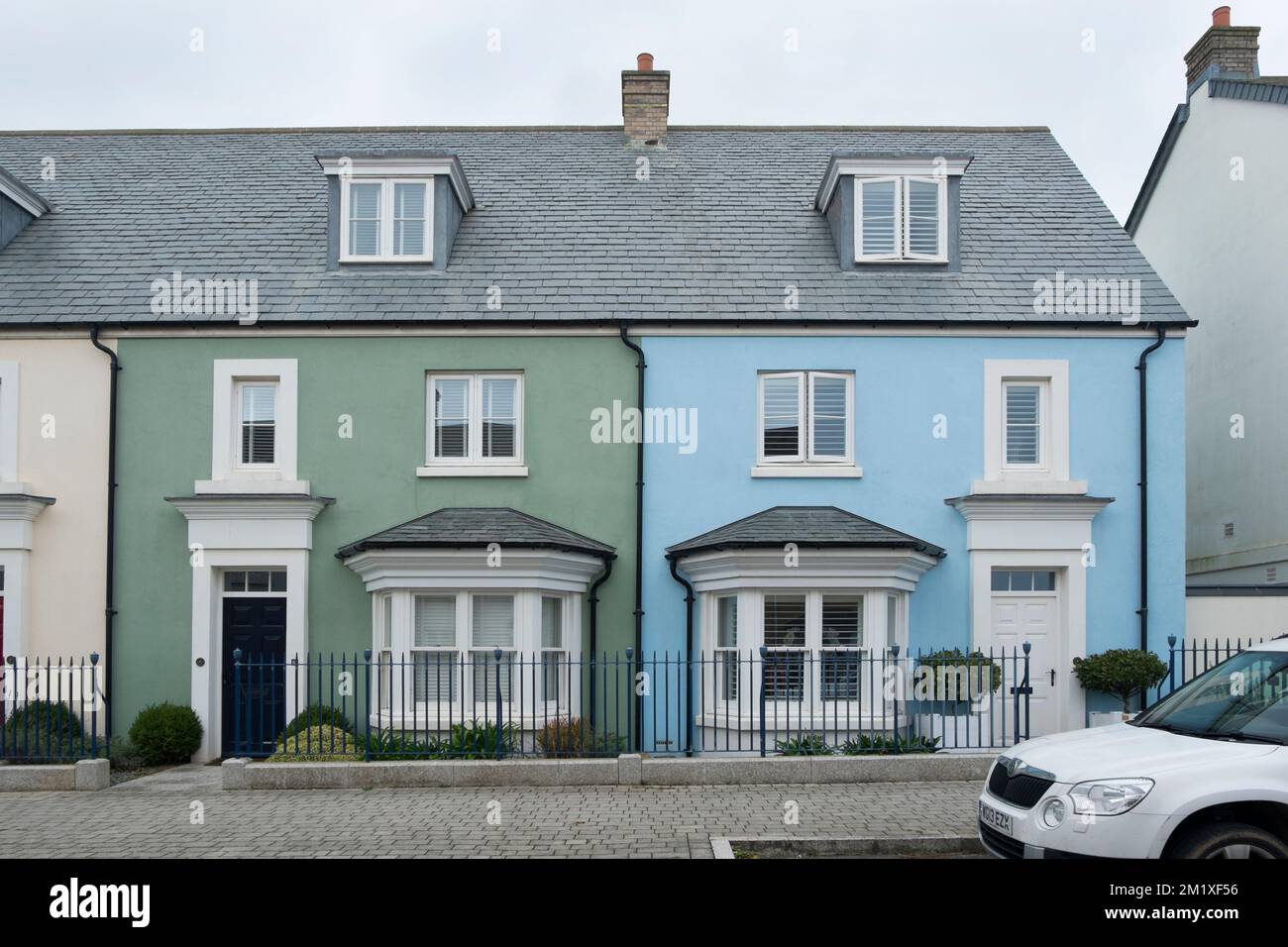 A row of three storey, terraced houses on Stret Euther Penndragon,Nansledan, a development by the Duchy of Cornwall in Newquay, South West England, UK Stock Photo