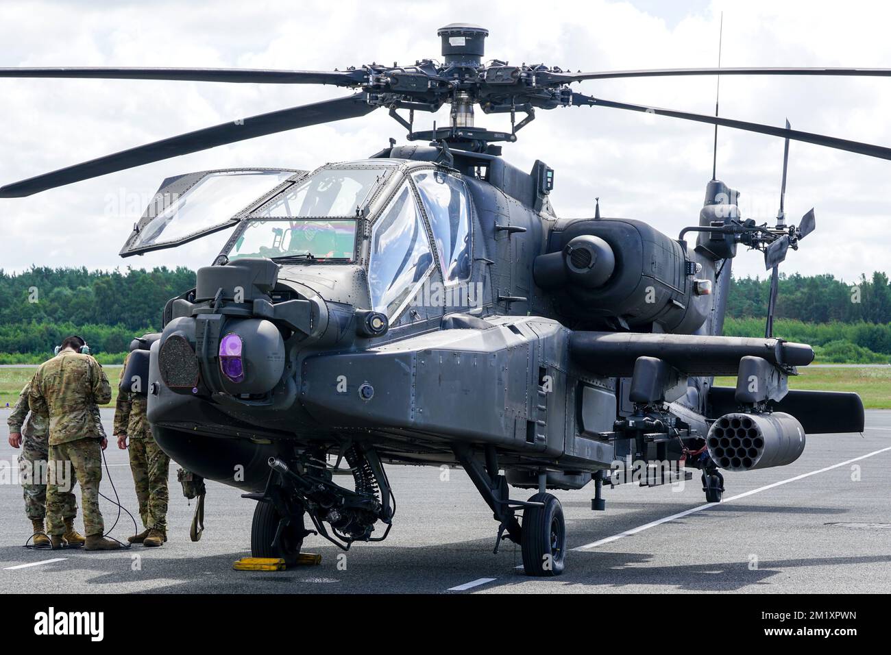 Liepaja, Latvia - August 07, 2022: AH-64D Apache attack helicopter from United States army with crew after landing at the airport runway Stock Photo