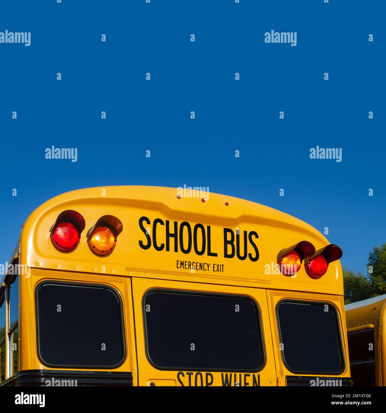 Rear of a School Bus with blue sky Stock Photo