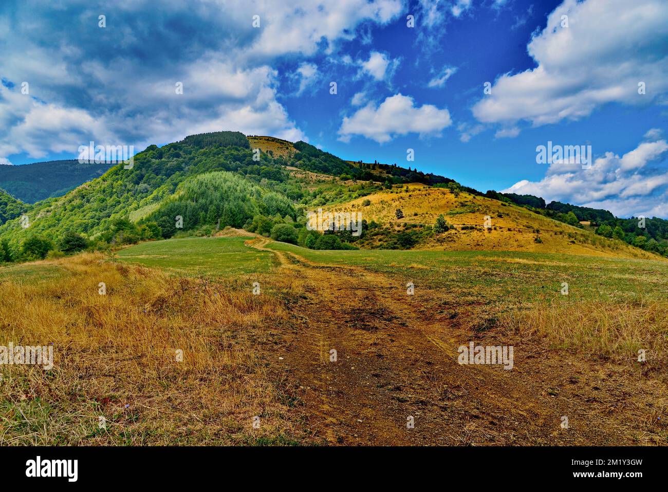 A scenic view of a hill under the beautiful blue sky Stock Photo - Alamy