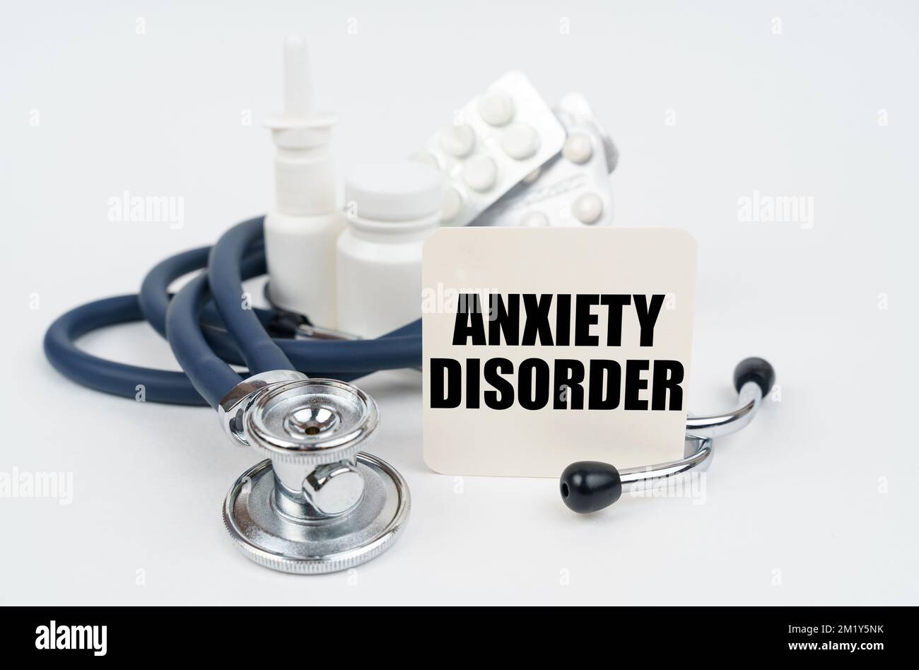 Medical concept. On a white surface, medicines, a stethoscope and writing paper with the text - Anxiety disorder Stock Photo