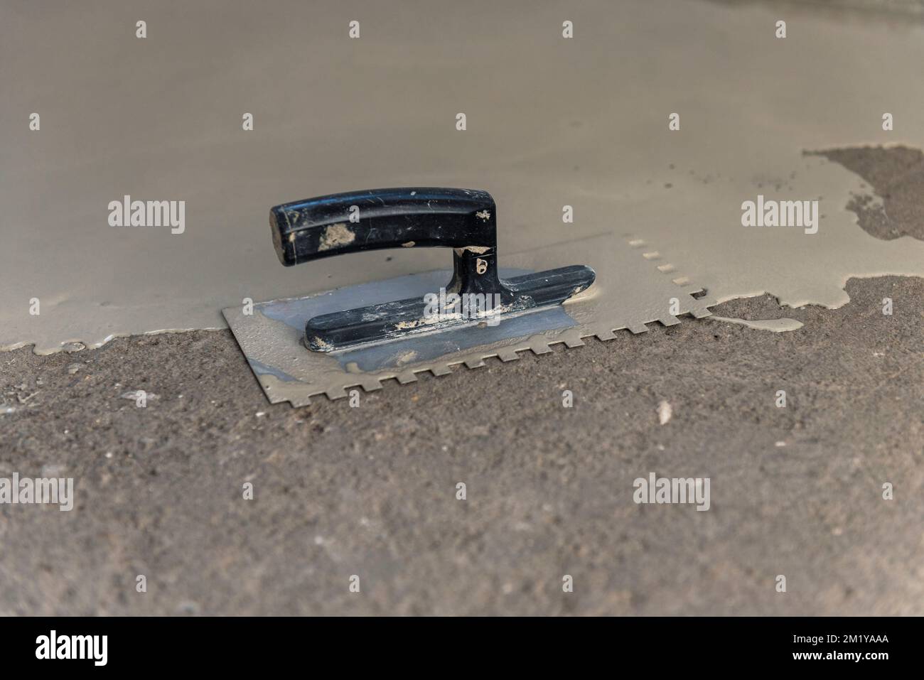 Construction workers are painting the floor using the method self