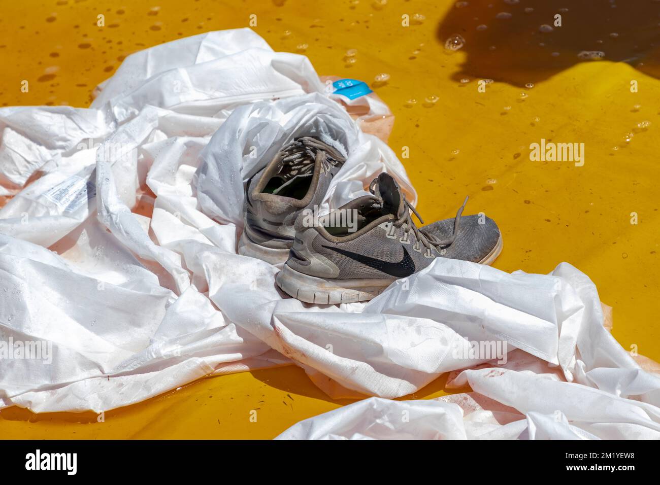Running shoes in a simulated chemical wash bath after removal from an
