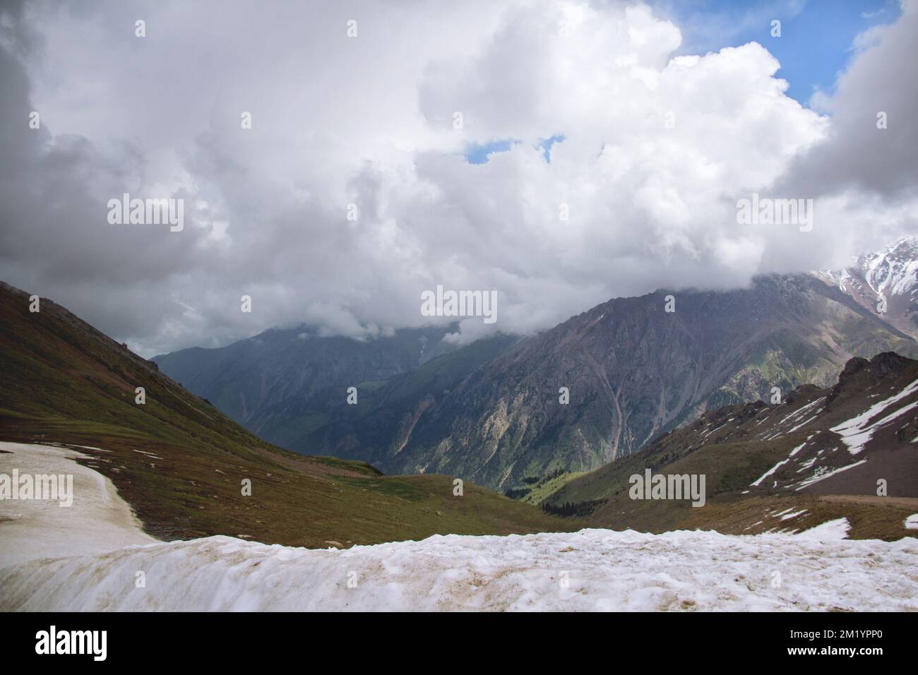 View of the alpine ridge with thick clouds in winter at the Chimbulak resort Stock Photo