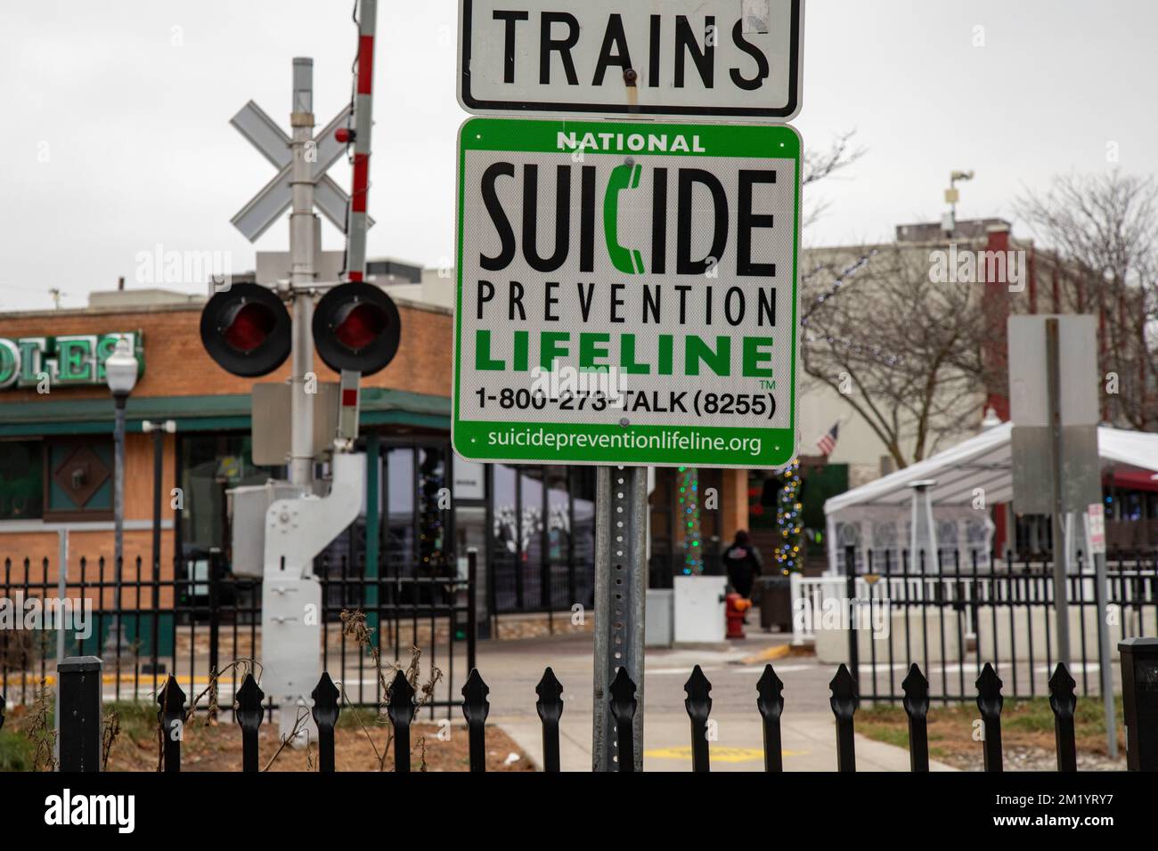 Royal Oak, Michigan - A suicide prevention phone number is posted at a pedestrian crossing for the CN Railroad. Stock Photo