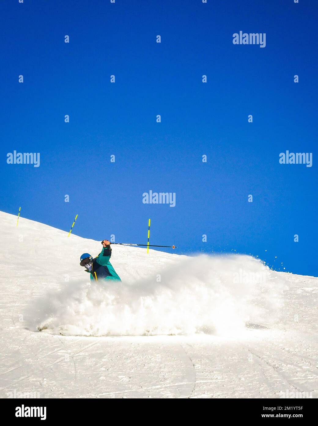 Professional skier at full speed ski downhill on fresh snow do carving